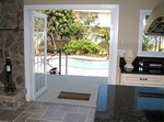 French doors open to the brick courtyards and pool area